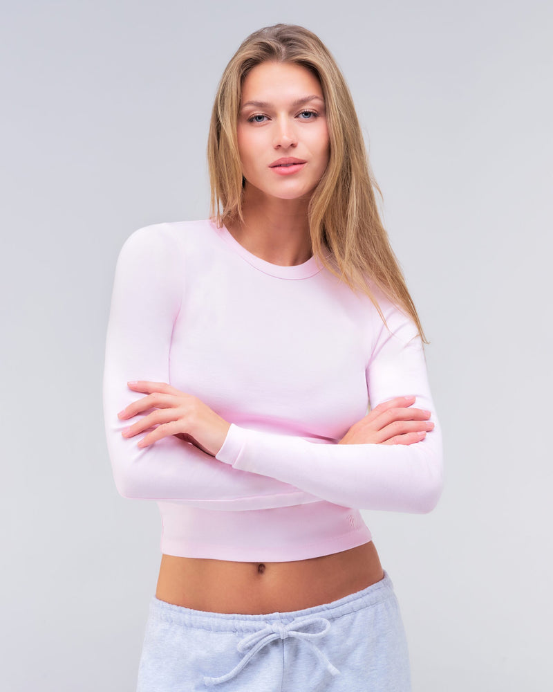 Alexa fitted crew neck long sleeve top in baby pink, three-quarter view