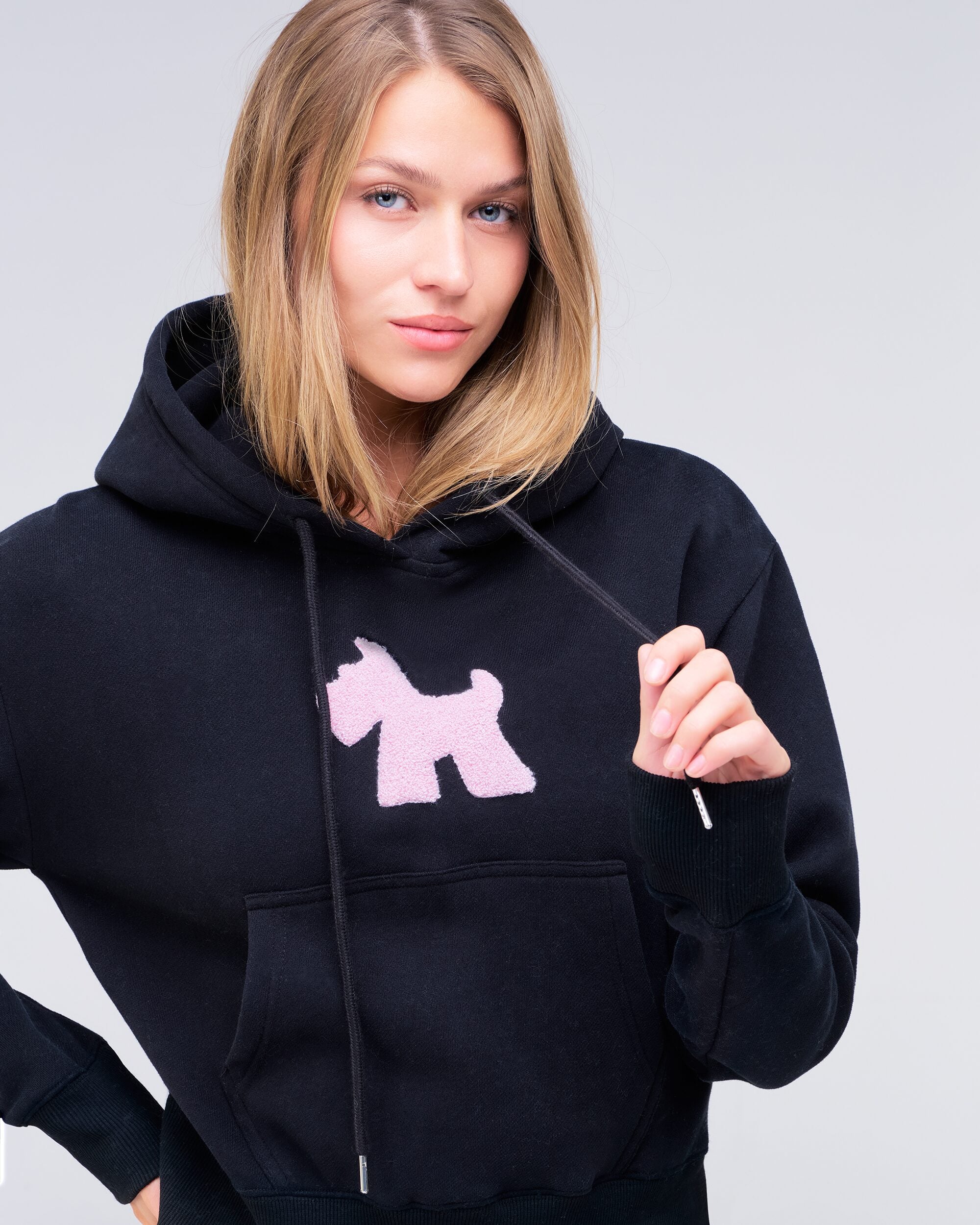 Emely cropped pullover hoodie in black with pink logo, front view