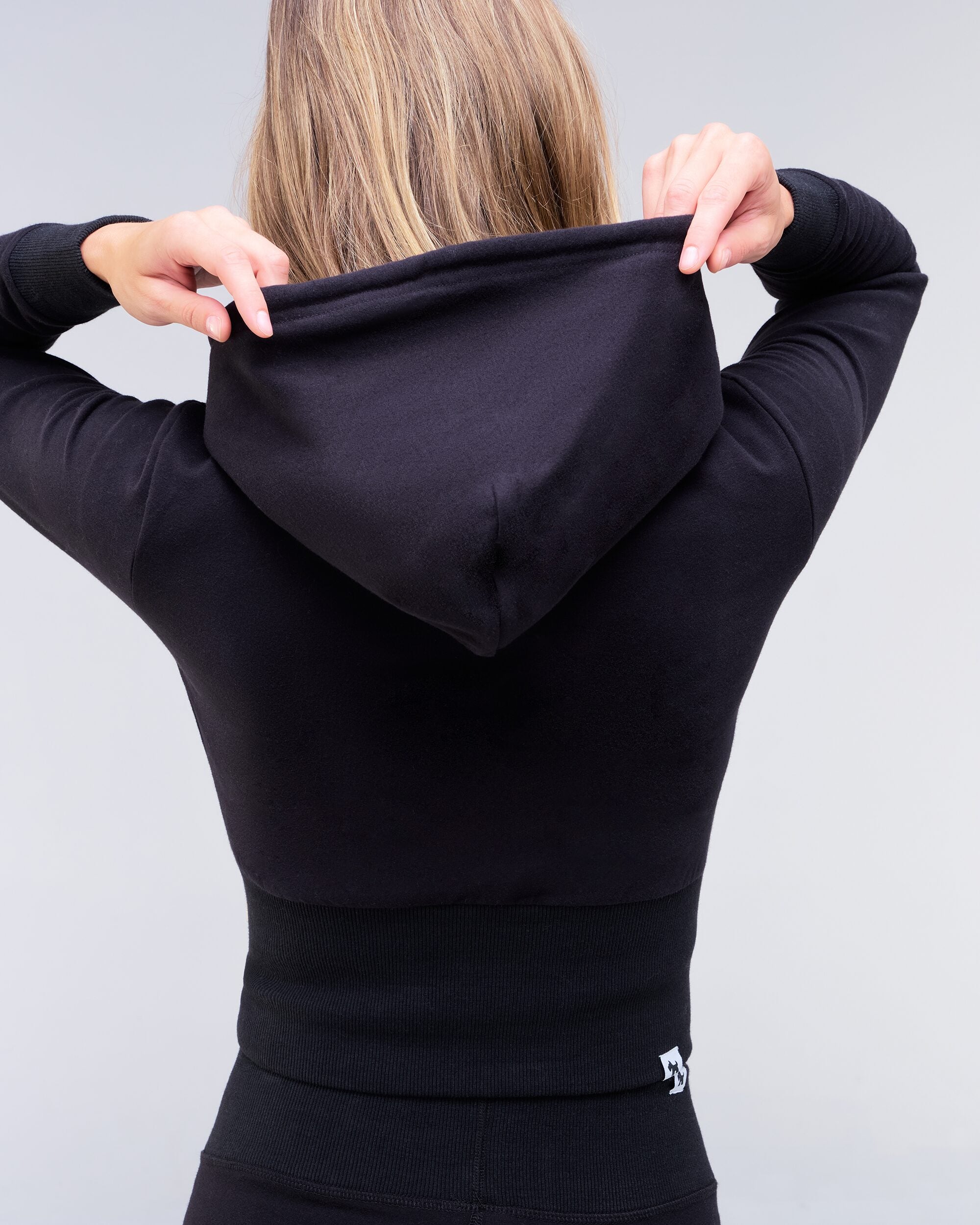 Payton fitted cropped zip-up hoodie in black, back view of hood