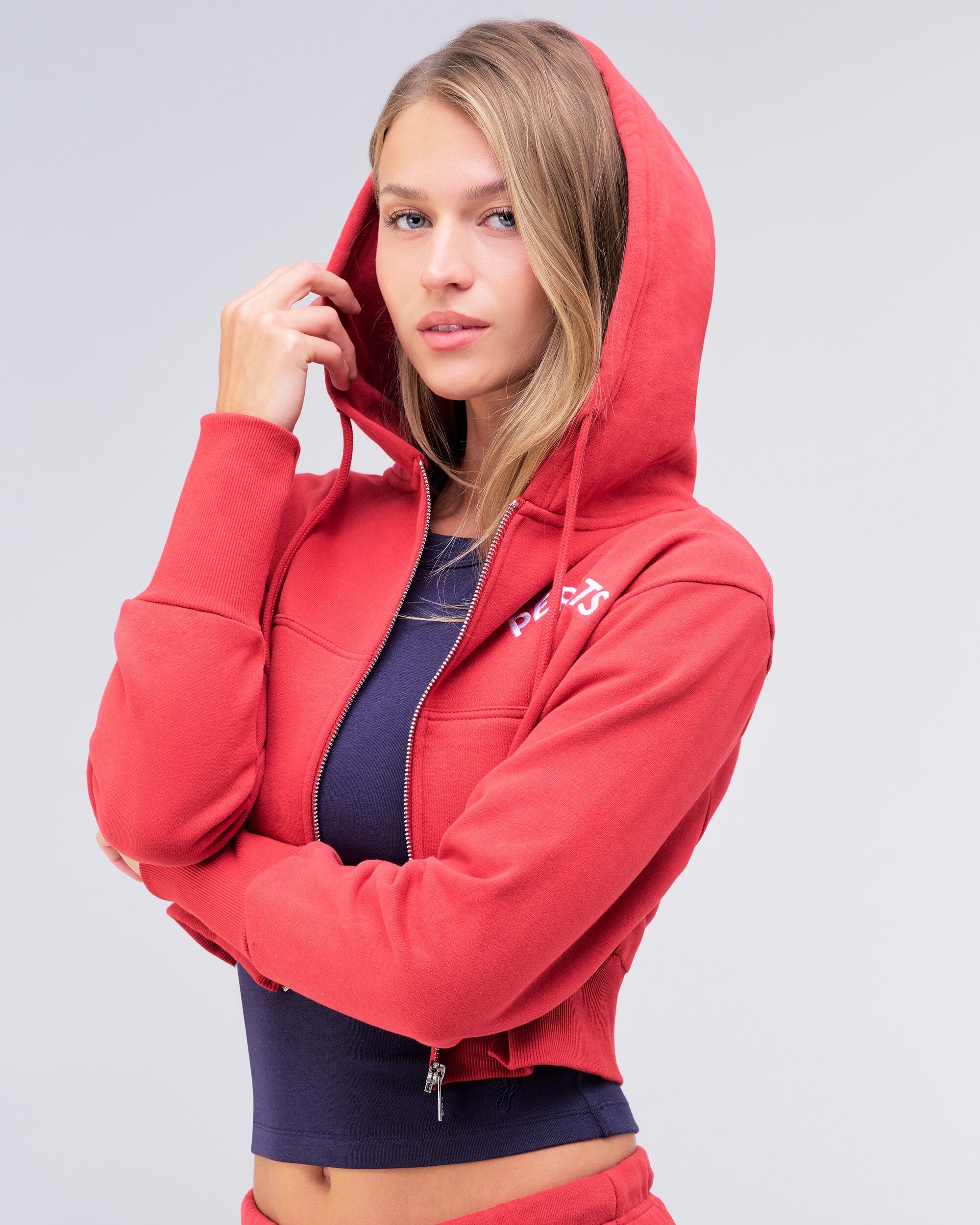 Berkley semi-fitted cropped zip-up hoodie in red, close-up with hood up