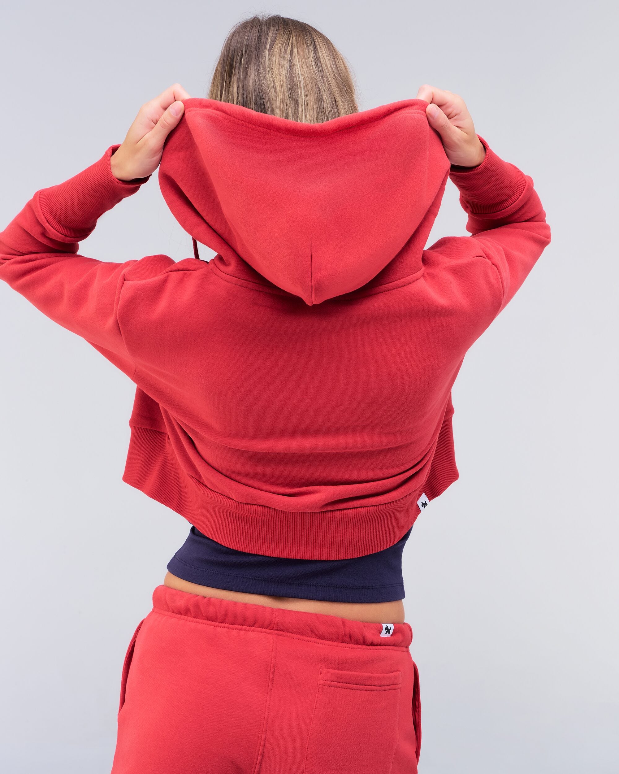 Berkley semi-fitted cropped zip-up hoodie in red, three-quarter back view