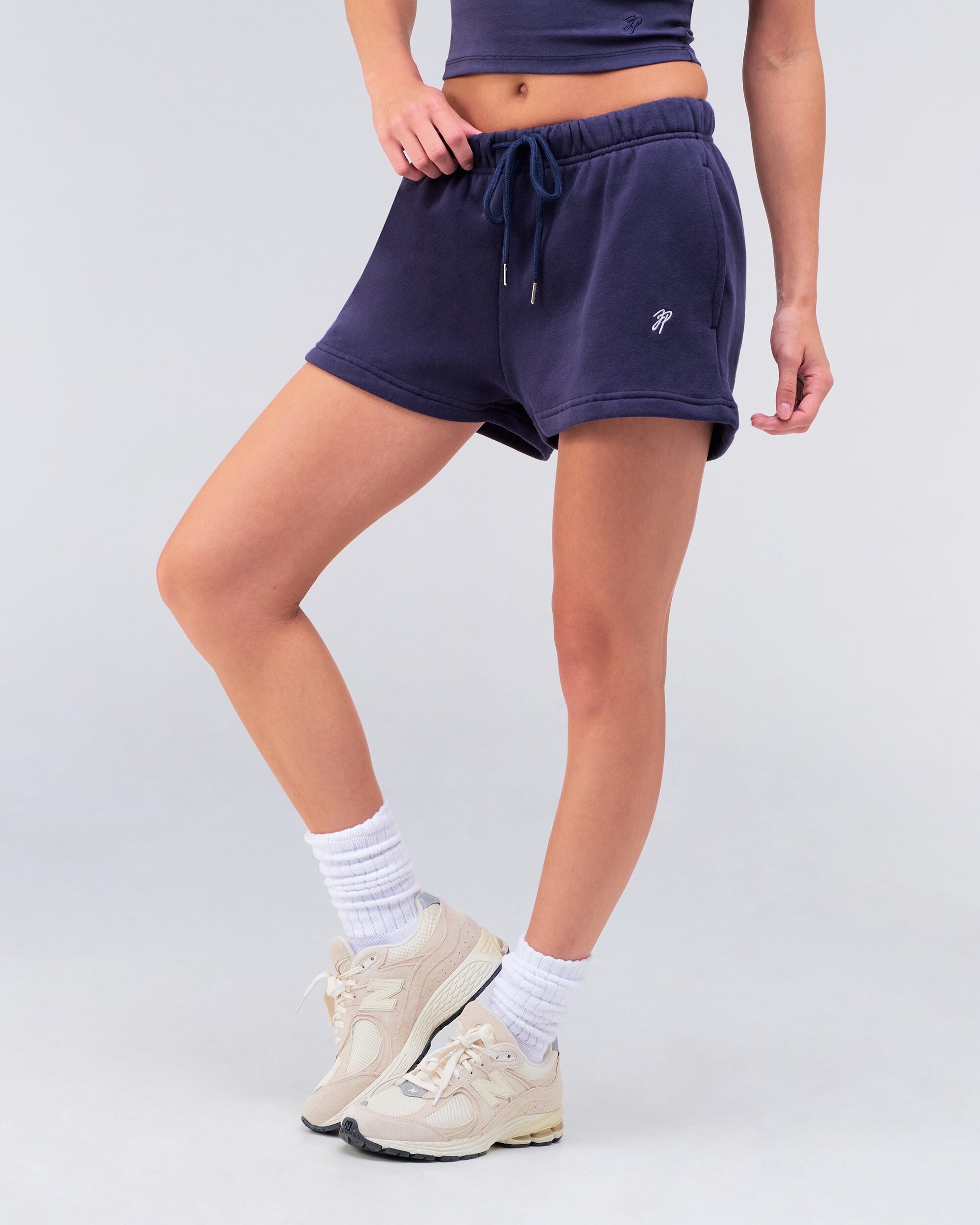 Danna relaxed sweat short in navy, side view with leg raised