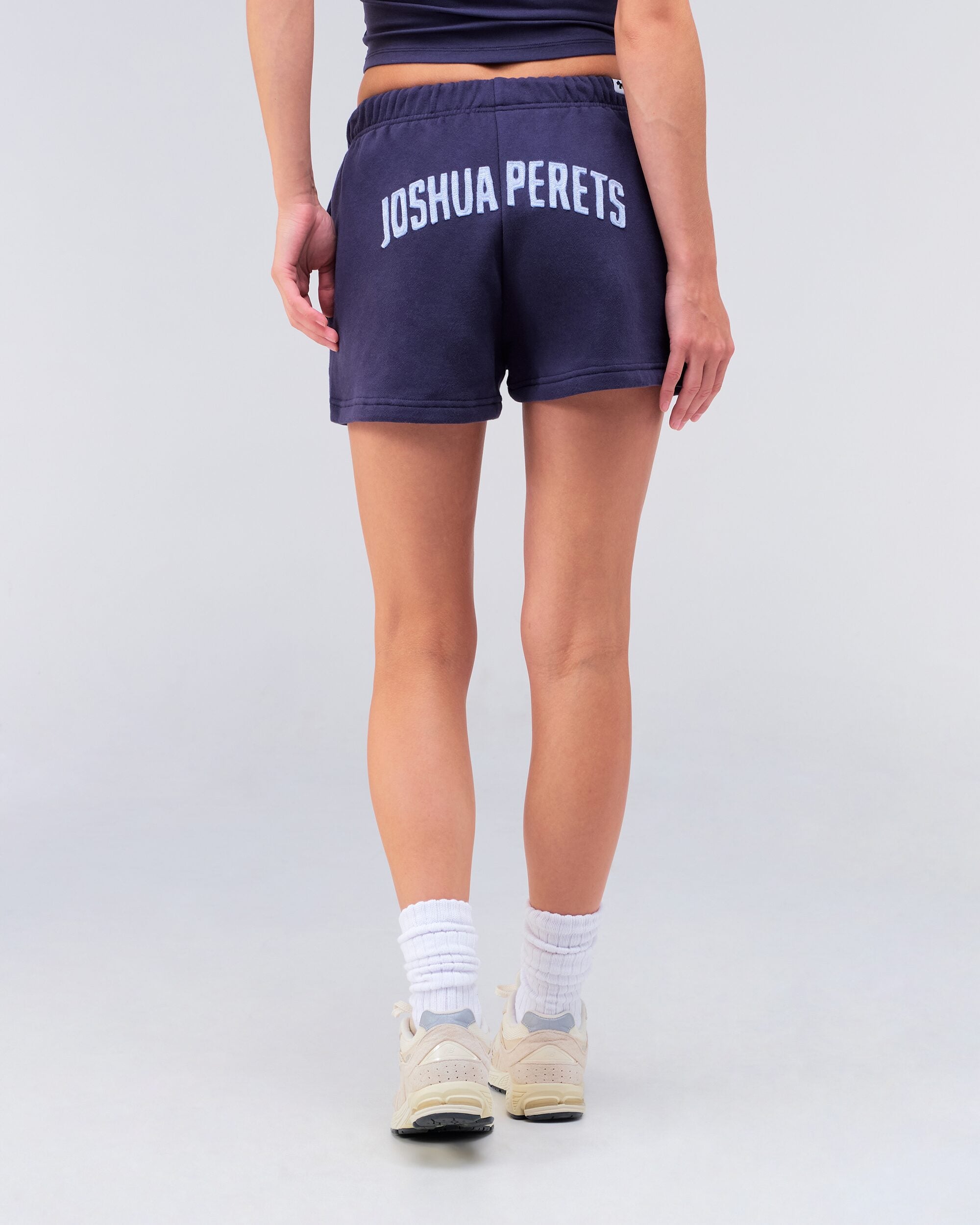 Danna relaxed sweat short in navy, back view walking