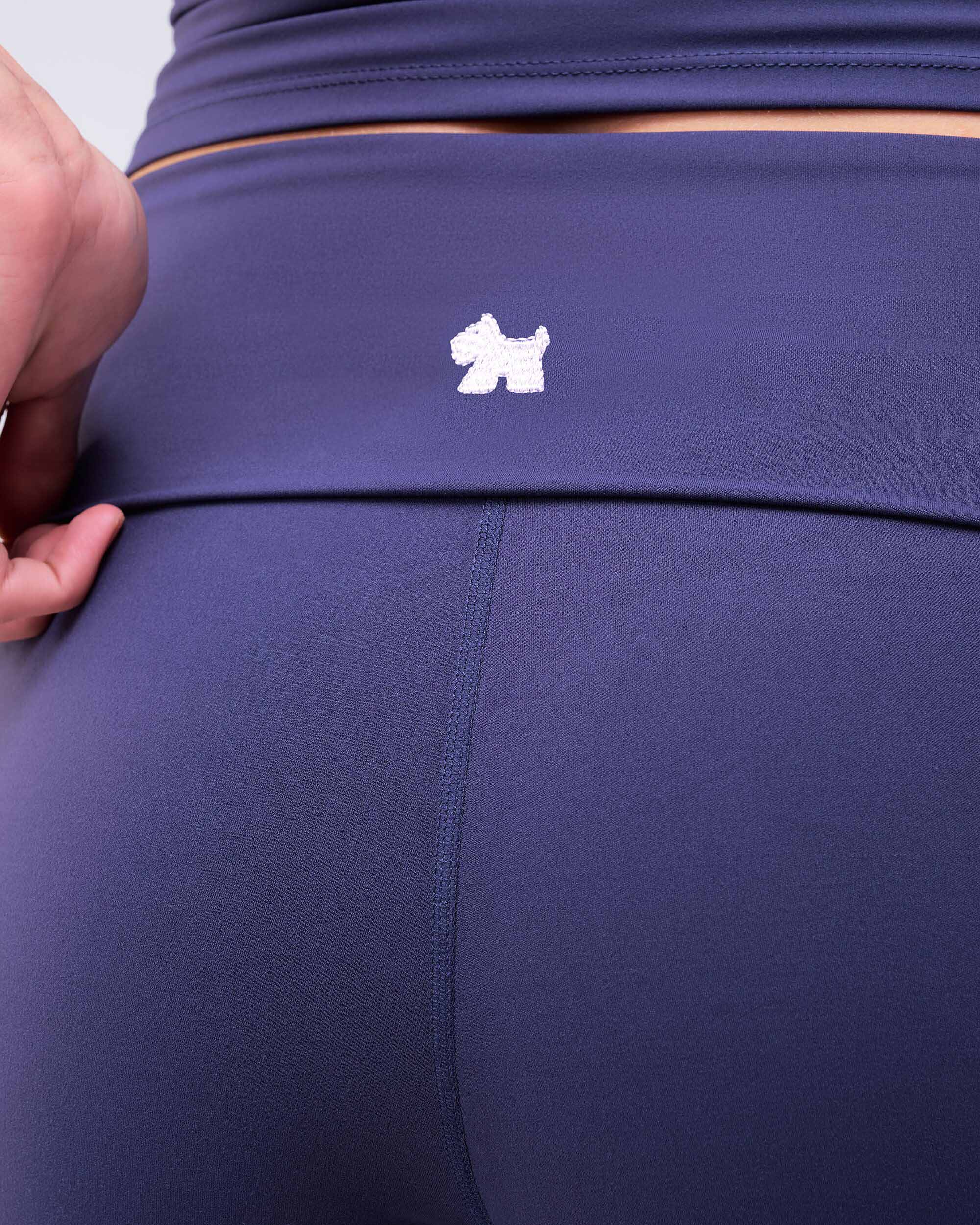 Fresh high-rise loose fit flare pants in navy, close-up of waistband logo