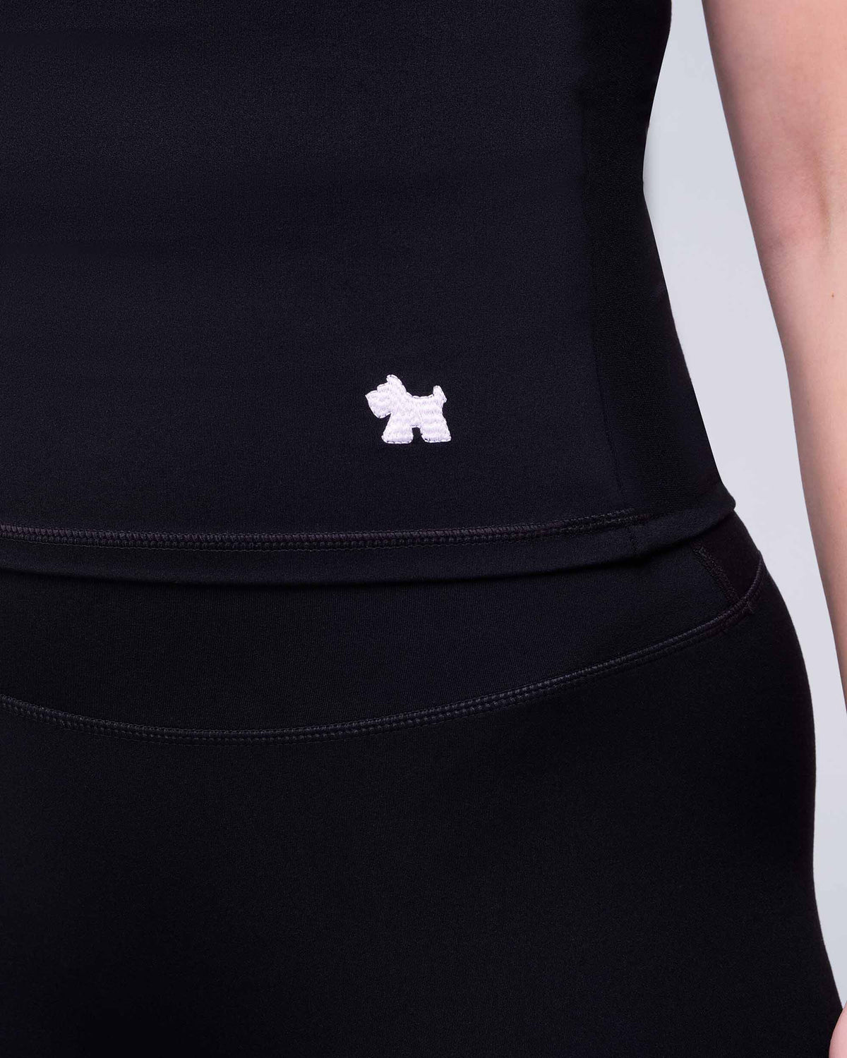Nicole Fitted Crew Neck Tee in Black - hem logo detail