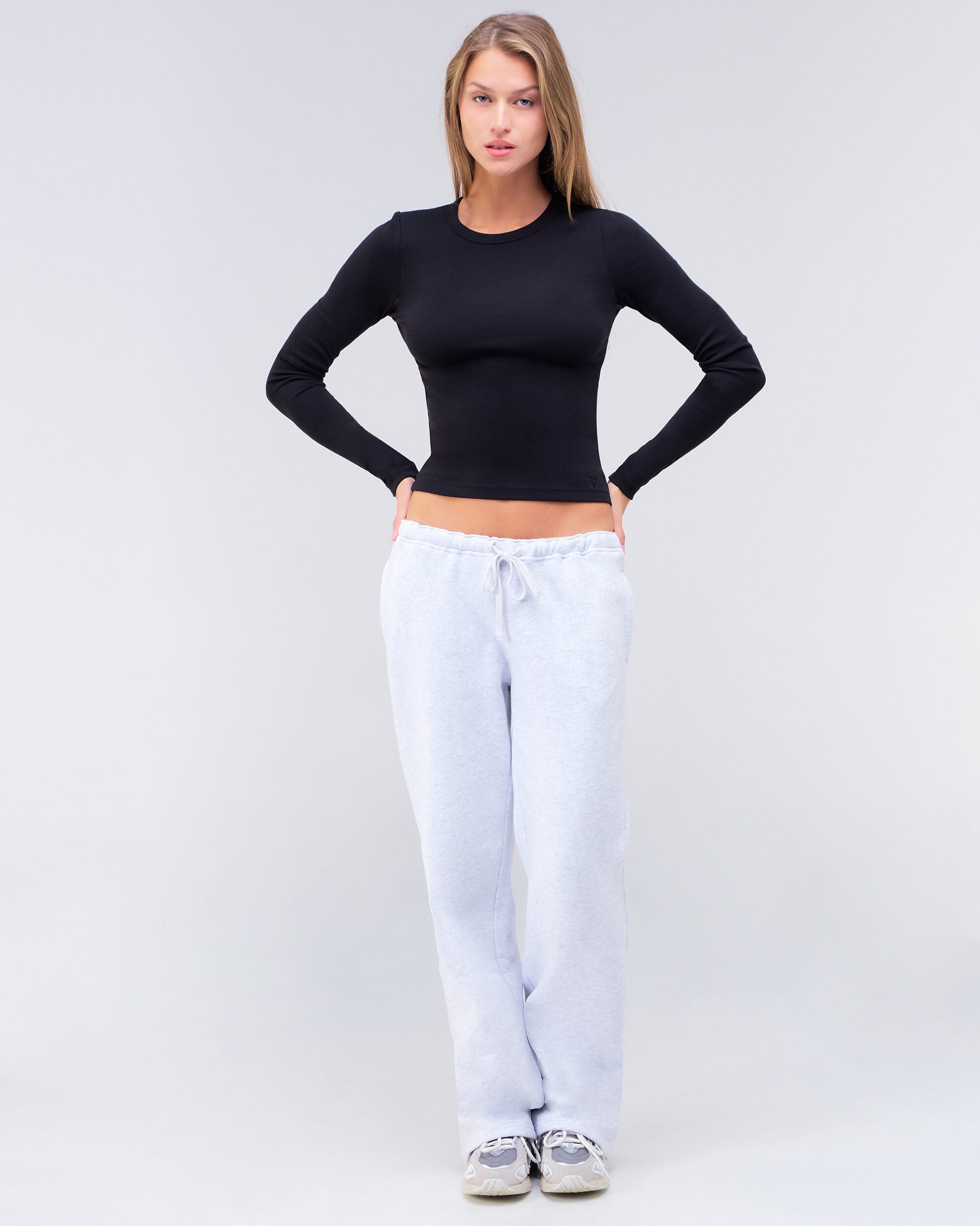 Alexa fitted crew neck long sleeve top in black, full body front view