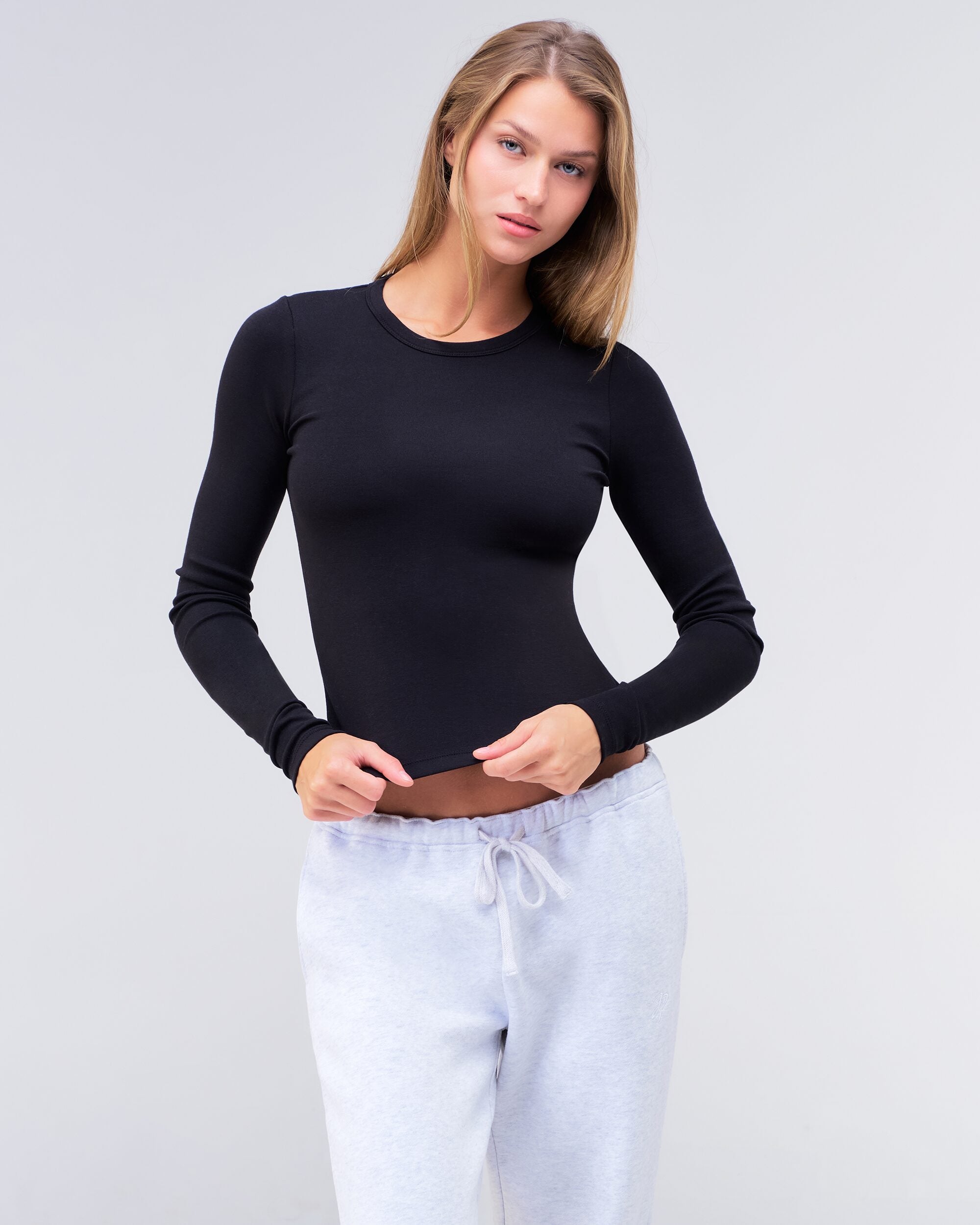 Alexa fitted crew neck long sleeve top in black, three-quarter view
