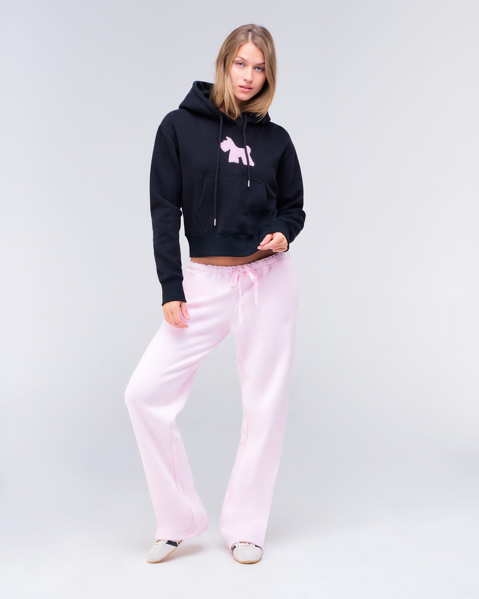 Emely cropped pullover hoodie in black with pink logo, full body front view