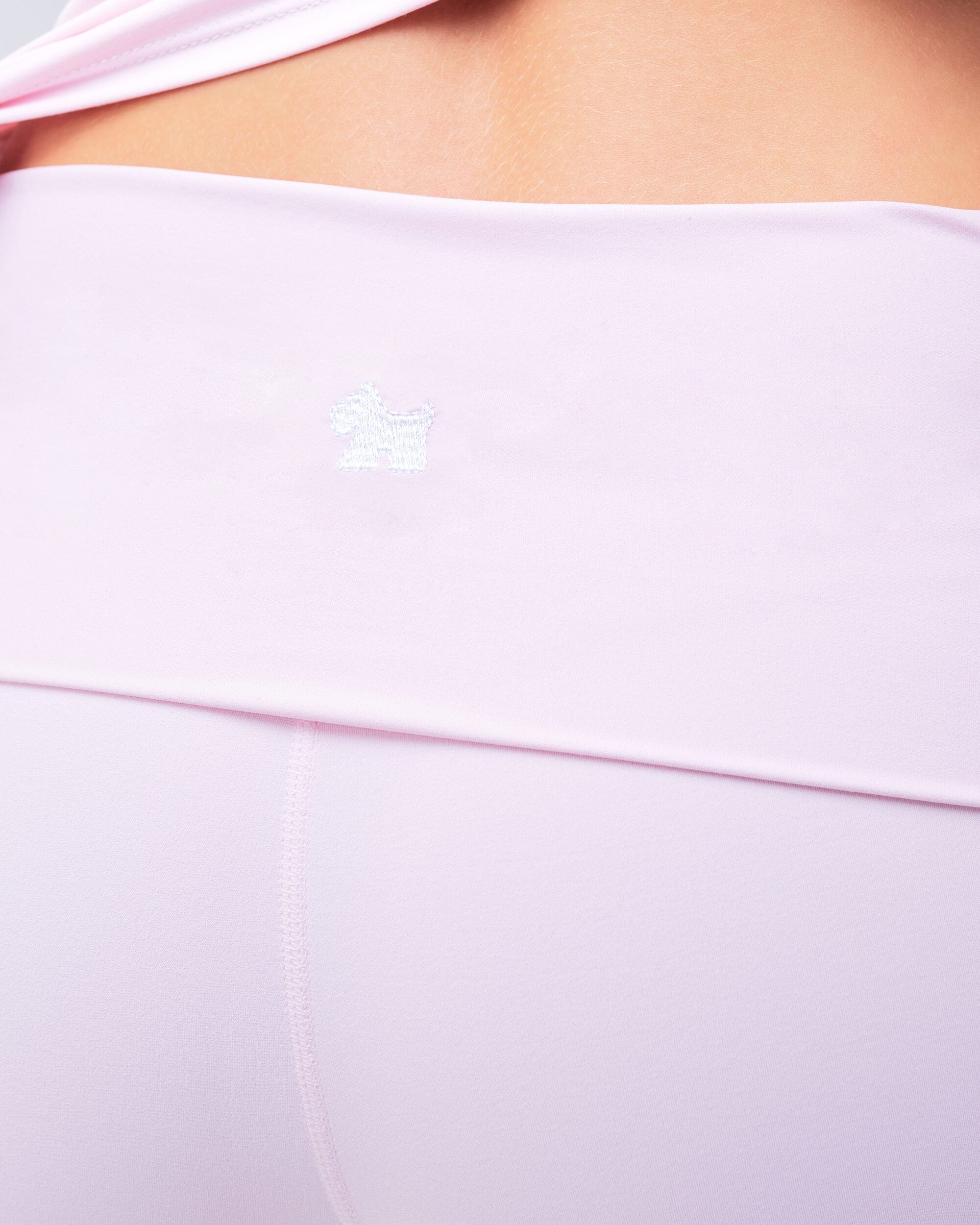 Andy fitted turnover flare pant in baby pink, close-up of waistband logo