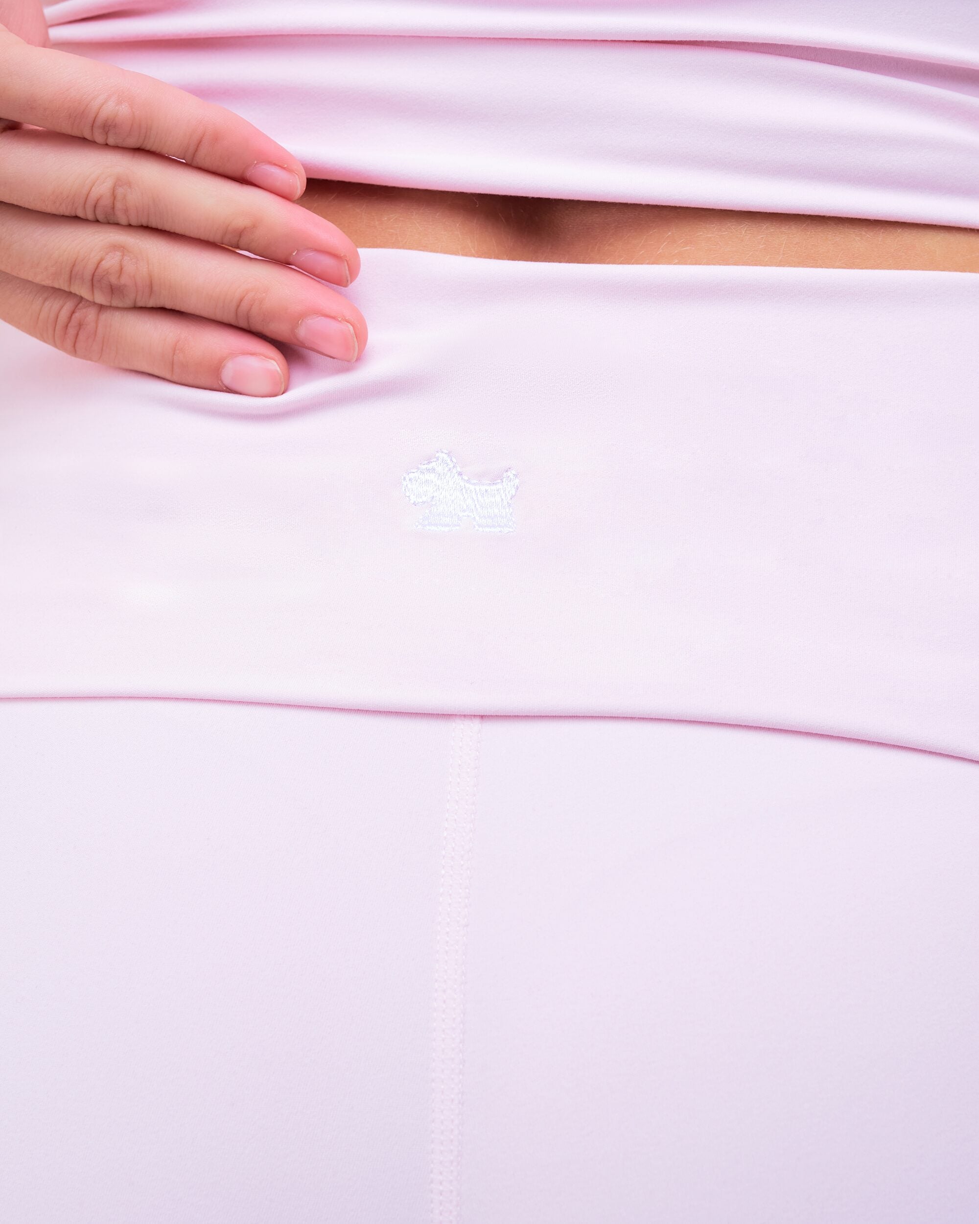 Fresh high-rise loose fit flare pants in baby pink, close-up of waistband