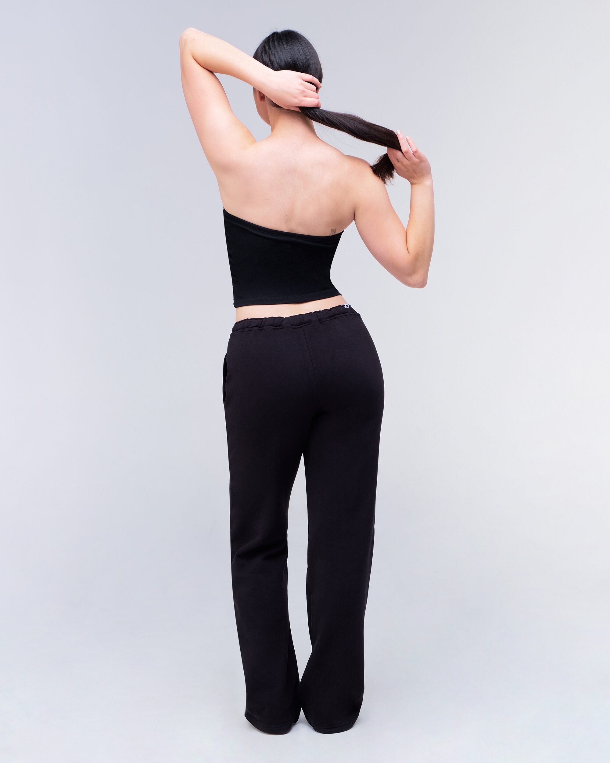 Gia Low-Rise Relaxed Fit Flared Sweatpants in Black - back full look