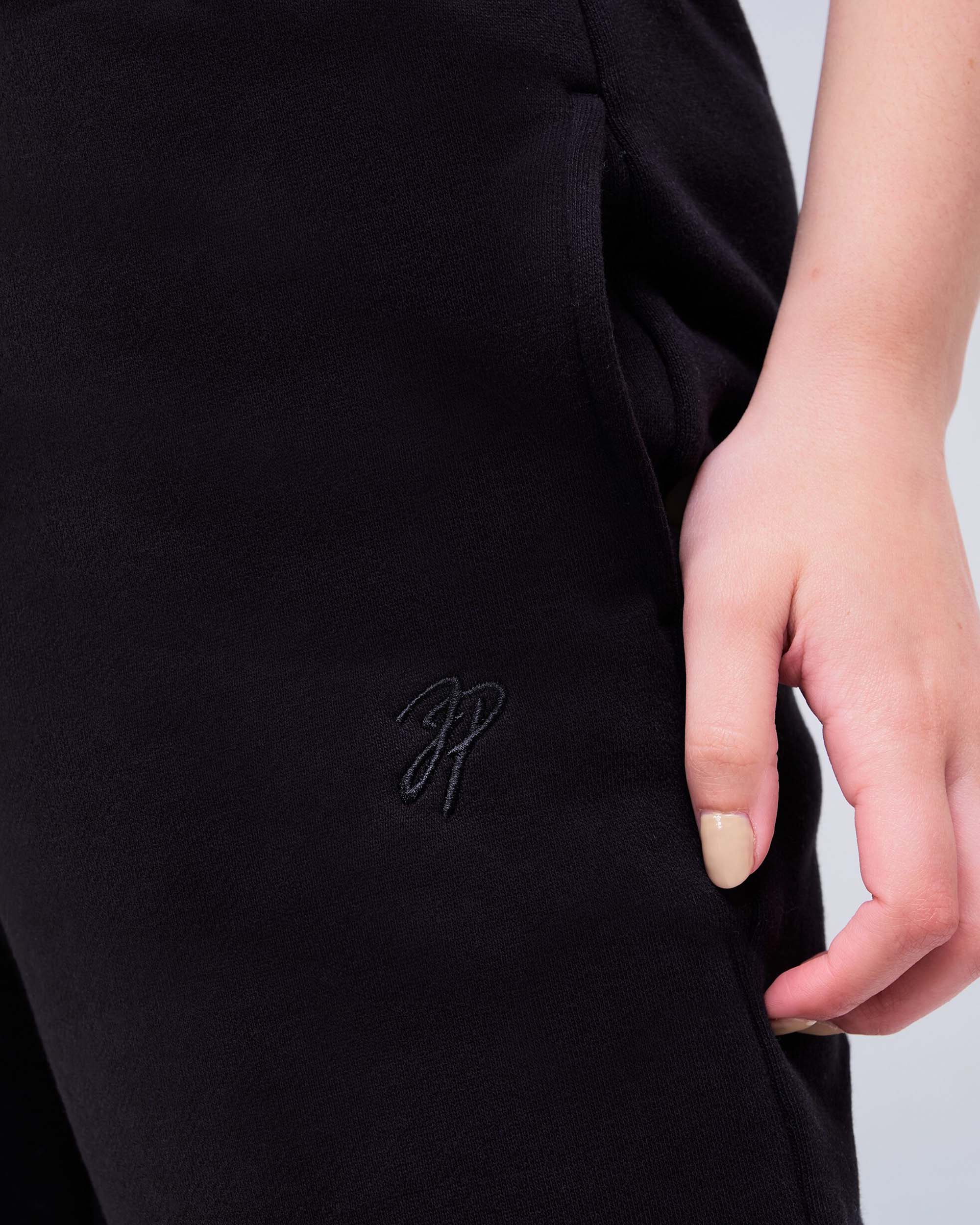 Gia Low-Rise Relaxed Fit Flared Sweatpants in Black - logo detail