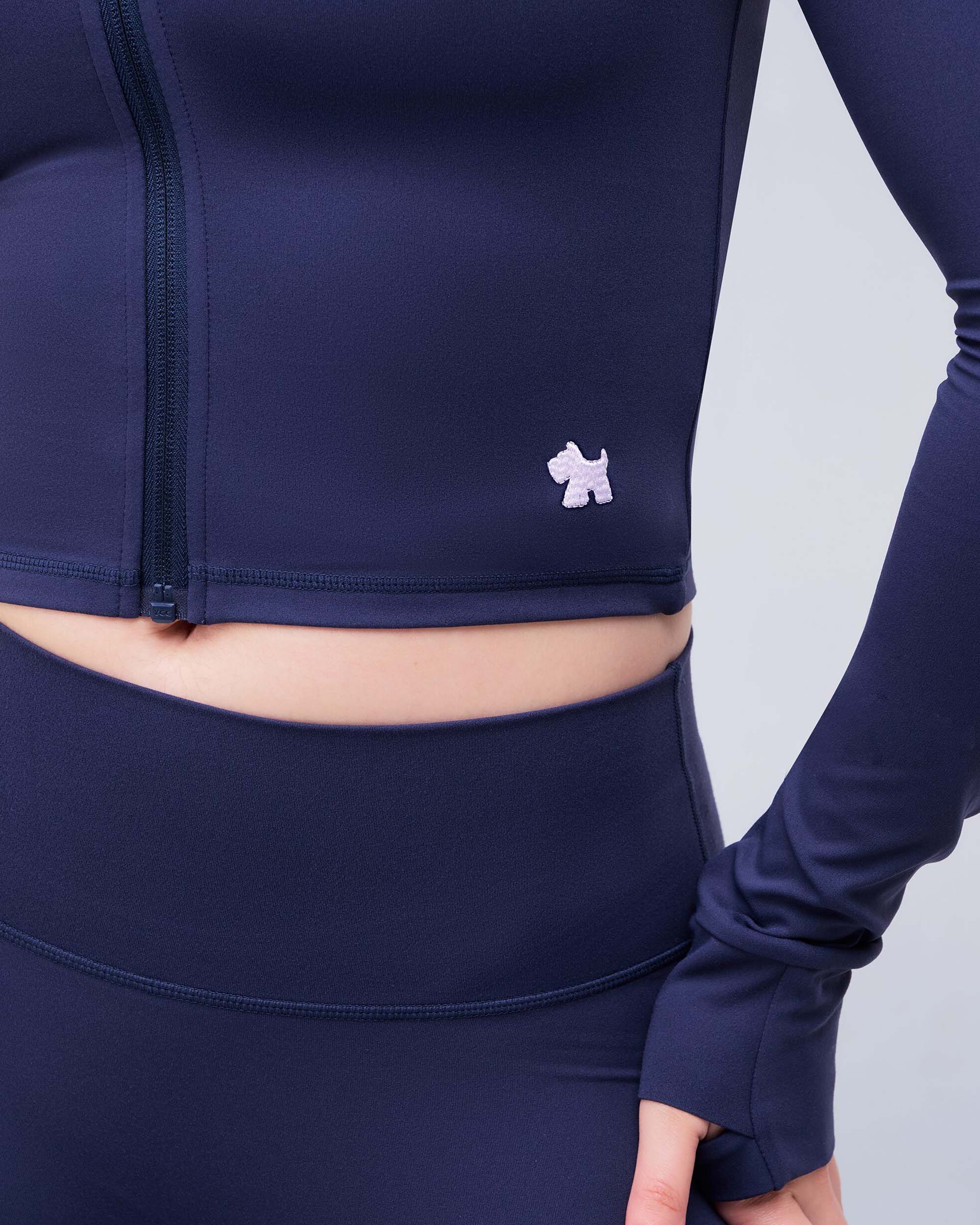 Shay Fitted Mock Neck Zip-Up Long Sleeve Top in Navy - hem logo detail
